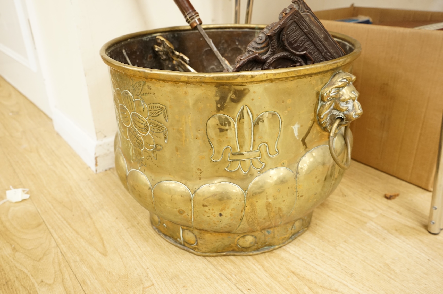 A 19th century Dutch brass coal bin, a pair of wall sconces, a copper bed warmer and three book slides